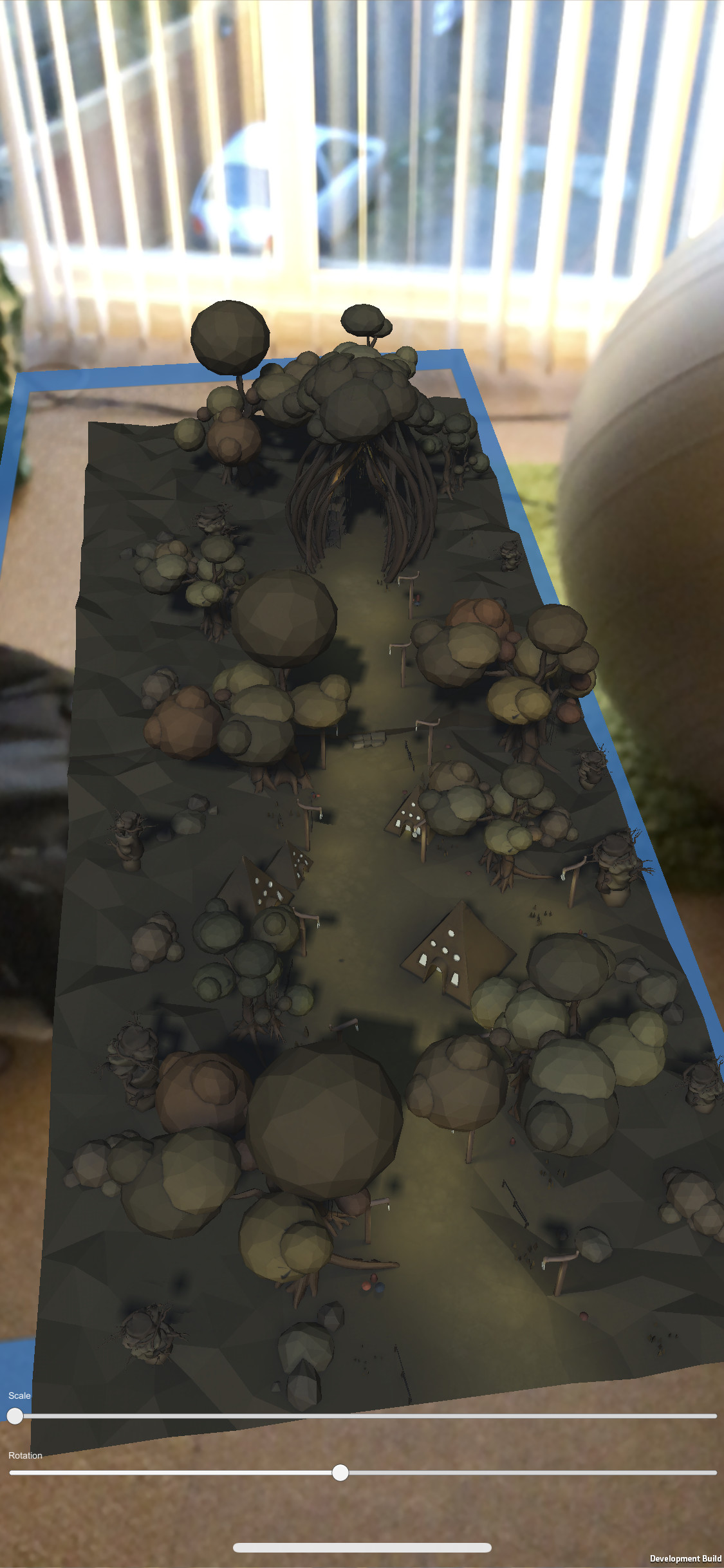 Placing it again, but with controls for rotation and scale. The blue
        outline represents where ARKit has detected a surface (on a messy floor in this case).